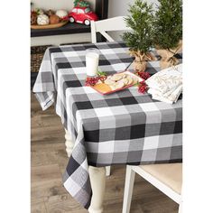 a black and white checkered table cloth on a dining room table with christmas decorations