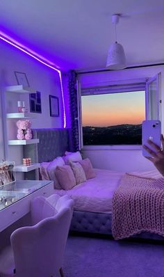 a woman taking a selfie in her bedroom at night with the lights turned on