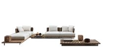 a modern living room with white couches and coffee table