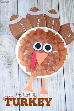 a paper plate turkey with footballs on it