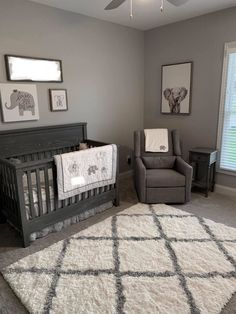 a baby's room with gray walls and white carpet