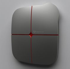 a silver and red computer mouse on a white surface