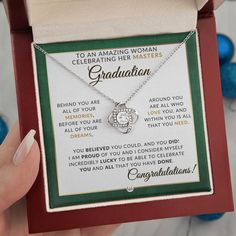 a woman's necklace is in a box with congratulations written on the front and back