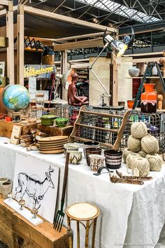 there are many items on the table in this room, including baskets and other things