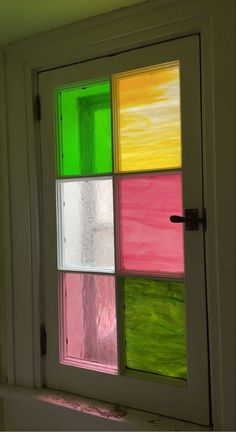 an open window with multicolored glass in it