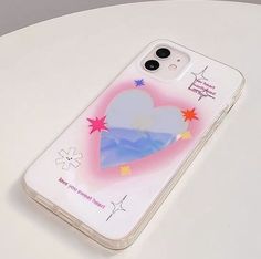 a phone case with an image of a heart on the front and stars in the back