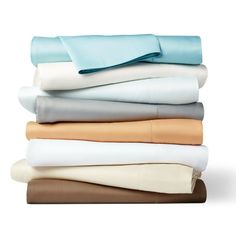 a stack of sheets and pillows on top of each other, with the sheets folded in different colors