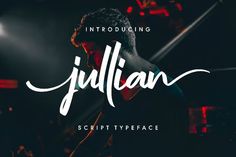 a script typeface with the name julian in white on a black background and red lights