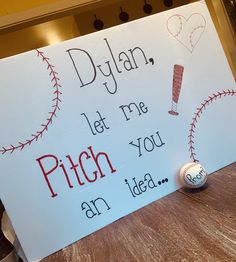 a sign that says, diyan let me pitch you an idea and a baseball on the table