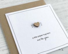 a little paper hug from me to you card with a wooden heart on the front