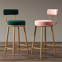 two stools with different colored upholstered backrests on wood flooring