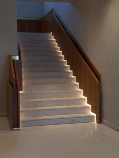 a set of stairs with illuminated steps leading up to the second floor in a house