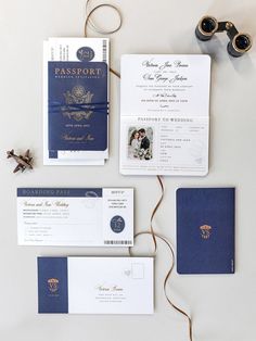 the wedding stationery is laid out on top of each other, including two passport cards