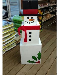 a cardboard snowman made to look like it is wearing a hat and scarf