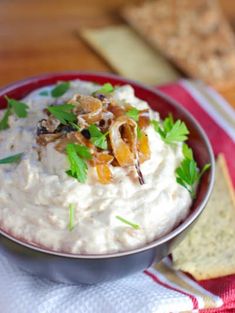 a bowl filled with white dip and garnished with parsley