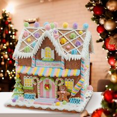 a decorated gingerbread house sits on a table