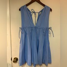 Super Cute New With Tags! Size Small Babydoll Dress. 100% Cotton. Would Look Cute Over A Shirt Or On Its Own In The Summer. Shoulder To Hem - 31” Across Chest Under Bust - 18” (Can Be Loose Or Cinched Tighter Than This) Blue V-neck Mini Dress With Tie Back, Light Blue Sleeveless Cotton Mini Dress, Light Blue Tie Back Mini Dress For Spring, Blue Sleeveless Mini Dress With Tie Back, Light Blue Sleeveless Dress With Tie Back, Blue Tie-back Daywear Dresses, Light Blue Cotton V-neck Dress, Blue Tie Back Dress For Daywear, Blue V-neck Dress With Tie Back