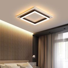 a bed room with a neatly made bed and a ceiling light above the headboard