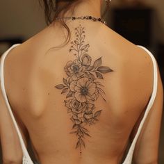 the back of a woman's neck with flowers on it