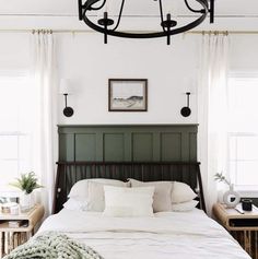 a bedroom with a large bed and green headboard