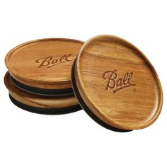 three wooden coasters with the word ball engraved on them, sitting next to each other