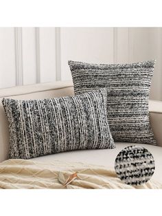 two black and white pillows sitting on top of a couch next to a pillow case