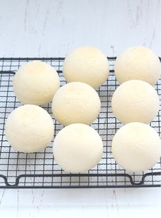 several balls of food sitting on a wire rack