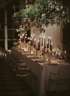 a long table is set with candles and flowers for an elegant dinner or party event