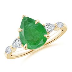 an emerald and diamond ring in yellow gold