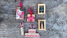 christmas ornaments are displayed on a wooden table with other items in the frame and around them