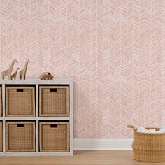 an empty room with pink wallpaper and wicker baskets in front of the basket