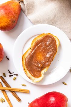 two pieces of bread with peanut butter on top and apples around them next to cinnamon sticks