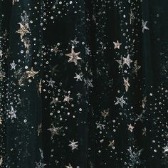 a black dress with gold stars and sequins