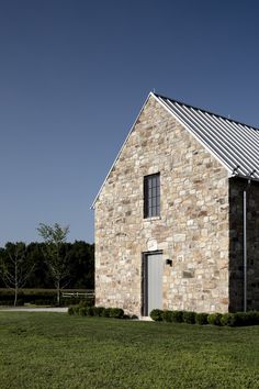 an old stone house with a metal roof