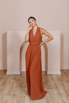 a woman in a red dress posing for the camera