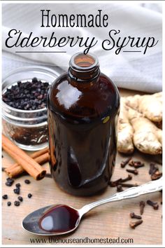 homemade elderberry syrup in a glass bottle with cinnamon sticks and cloves around it