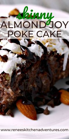 a close up of a piece of cake on a plate with almonds and chocolate