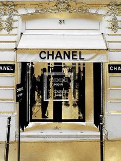 a chanel store front with gold and black accents