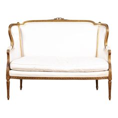 a white couch with gold trimmings on it's back and armrests