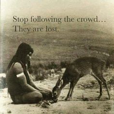 a native american man feeding a deer on the side of a road with a quote above it