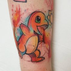 an arm with a colorful pokemon tattoo on it