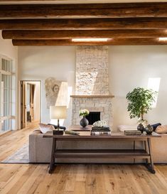 a living room filled with furniture and a fire place in the middle of a room