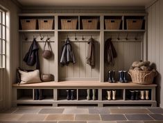 a wooden bench sitting next to a window filled with boots and bags on top of it