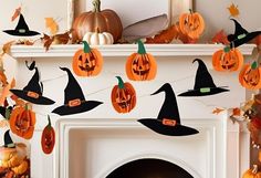 a fireplace decorated for halloween with pumpkins and witch hats