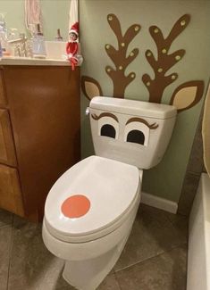 a bathroom with a toilet decorated like a reindeer