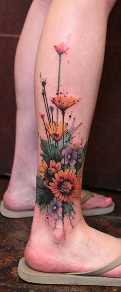 a woman's leg with flowers on it