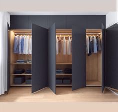 an open closet with clothes hanging in it