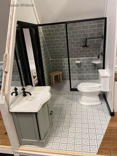 a bathroom with a toilet, sink and shower stall