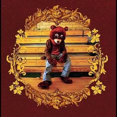 a teddy bear sitting on top of a wooden bench with an ornate frame around it