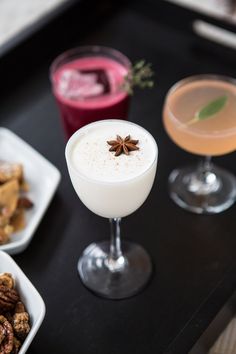 three different types of cocktails are on the table next to each other, including one with anisette